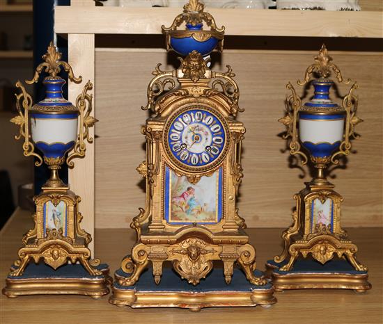 A Louis XV style gilt metal and porcelain mounted three piece clock set